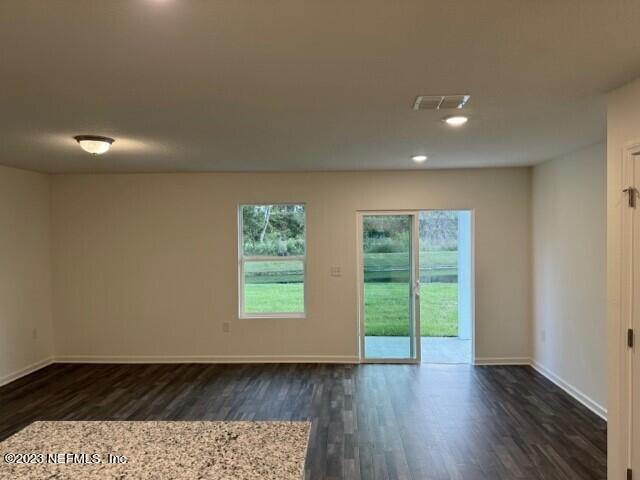 45113 Red Brick Drive Callahan, FL 32011 - Photo 5 of 9 an empty room with wooden floor and windows