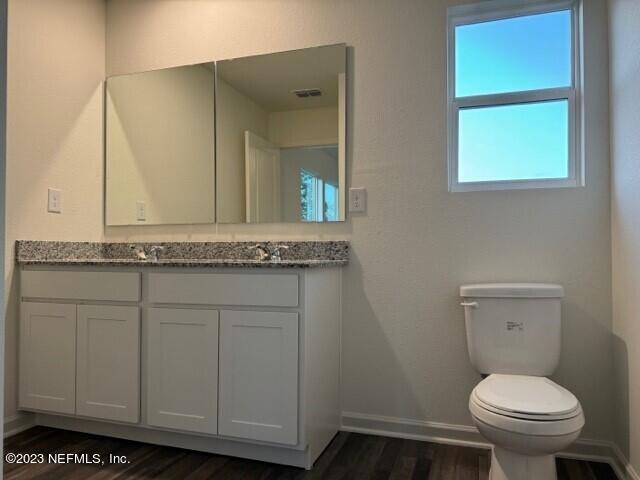 45113 Red Brick Drive Callahan, FL 32011 - Photo 8 of 9 a bathroom with a granite countertop toilet and a sink