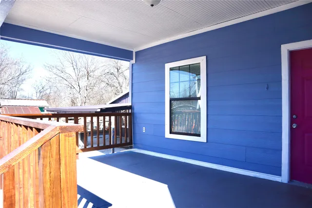 a view of hallway with furniture and windows