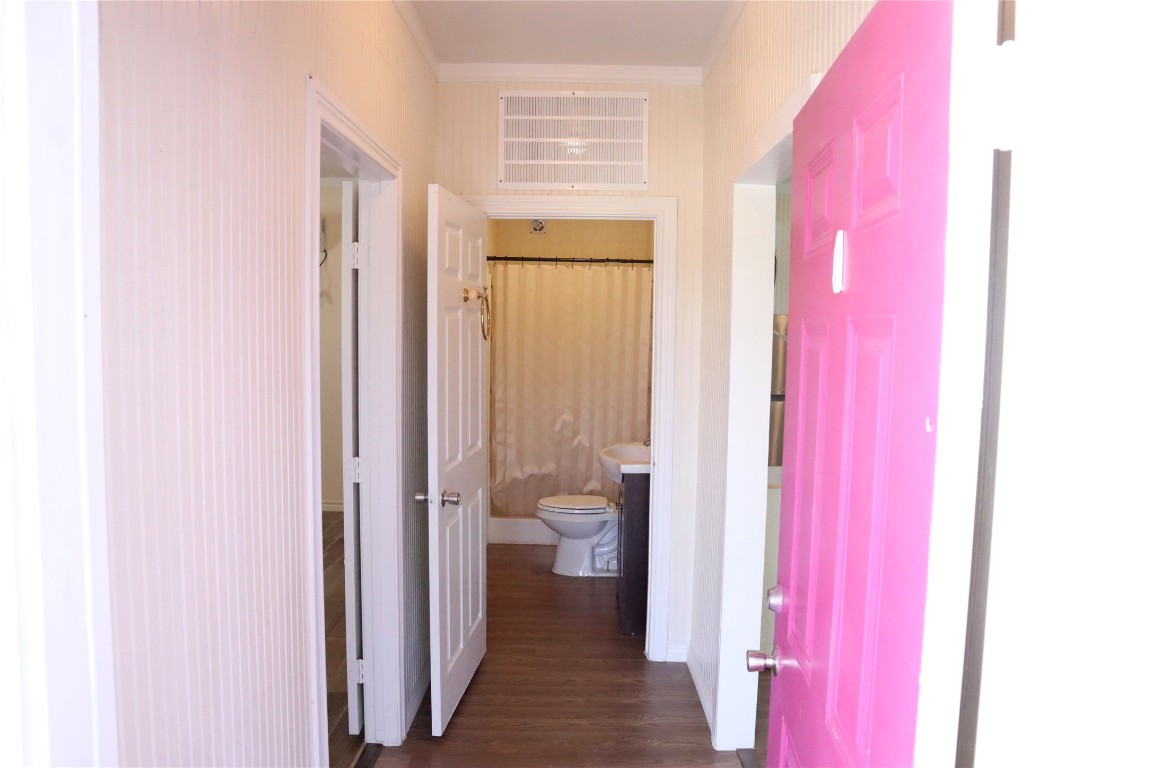 2689 County Road 32 Angleton, TX 77515 - Photo 4 of 15 Nice hallway entry featuring a charming pink front door that adds a pop of color and a warm, welcoming feel.