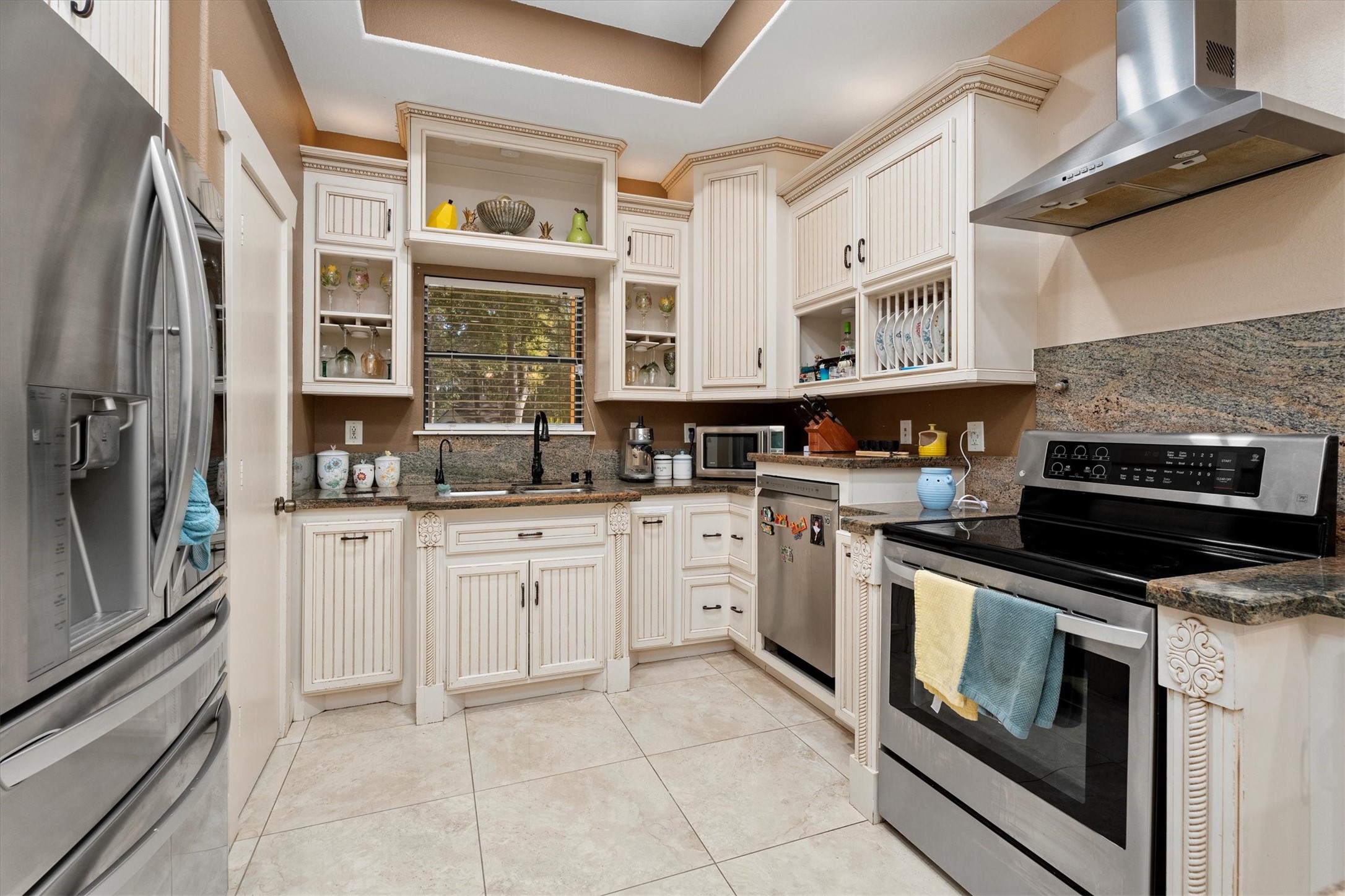 22924 Rio Grande Drive Porter, TX 77365 - Photo 11 of 19 a kitchen with stainless steel appliances granite countertop a stove and a refrigerator