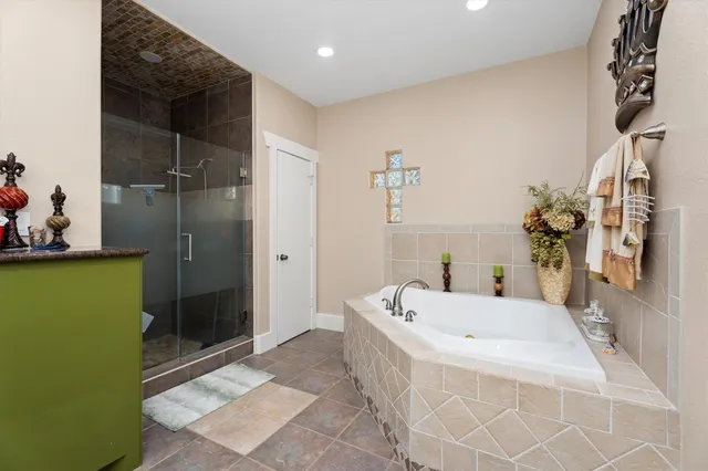 a bathroom with a tub and a shower