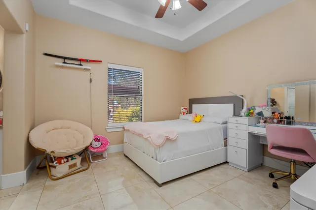 a white bed sitting in a bedroom next to a window