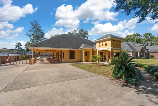 a view of house with outdoor space and garden