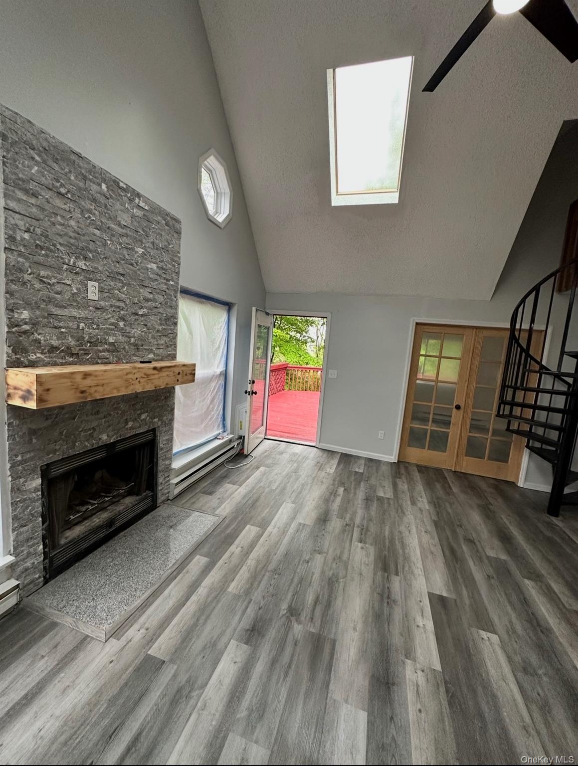 15 Fox Ridge Woodridge, NY 12789 - Photo 12 of 25 an empty room with wooden floor fireplace and windows