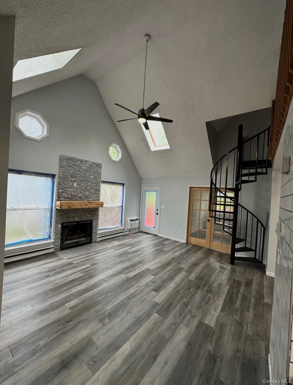 15 Fox Ridge Woodridge, NY 12789 - Photo 21 of 25 a view of a livingroom with a fireplace a ceiling fan and wooden floor