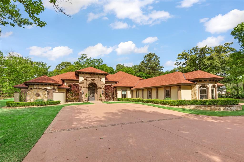 3705 Champions Ridge Lane Longview, TX 75605 - Photo 2 of 40 a front view of a house with a garden