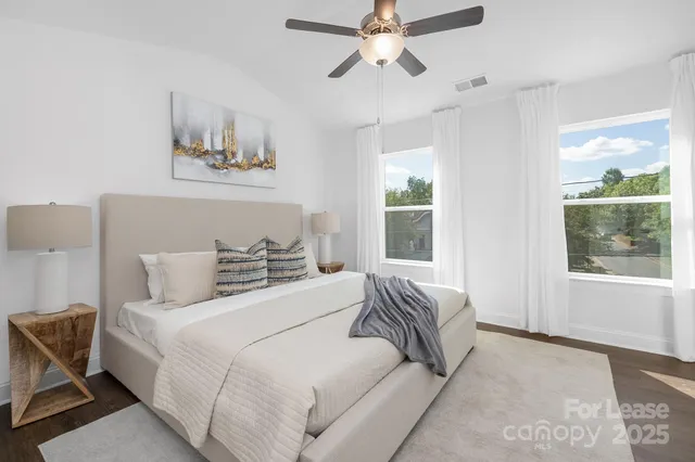 a bedroom with a large bed and a window