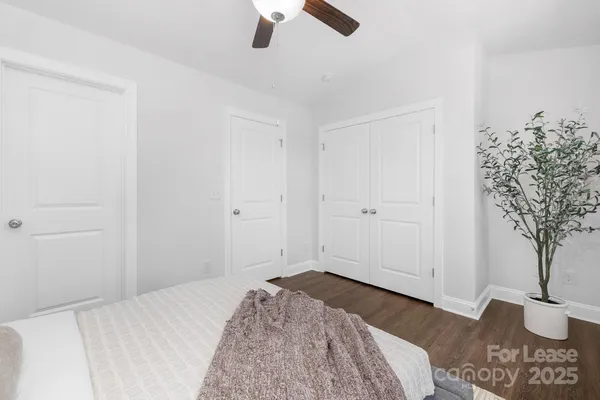a bedroom with a bed and a potted plant