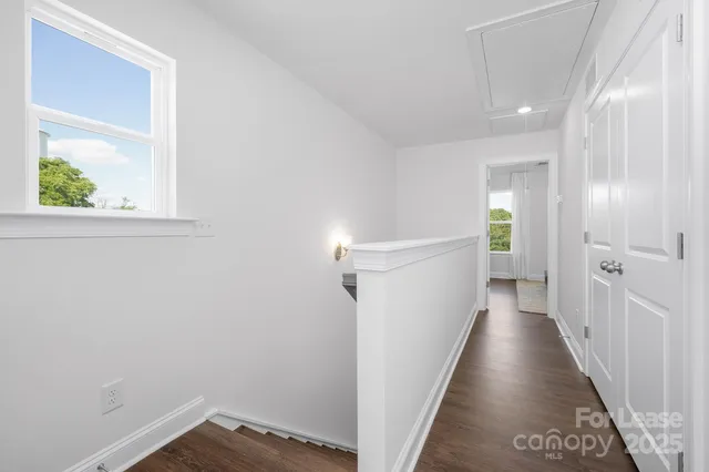 a view of a hallway with wooden floor