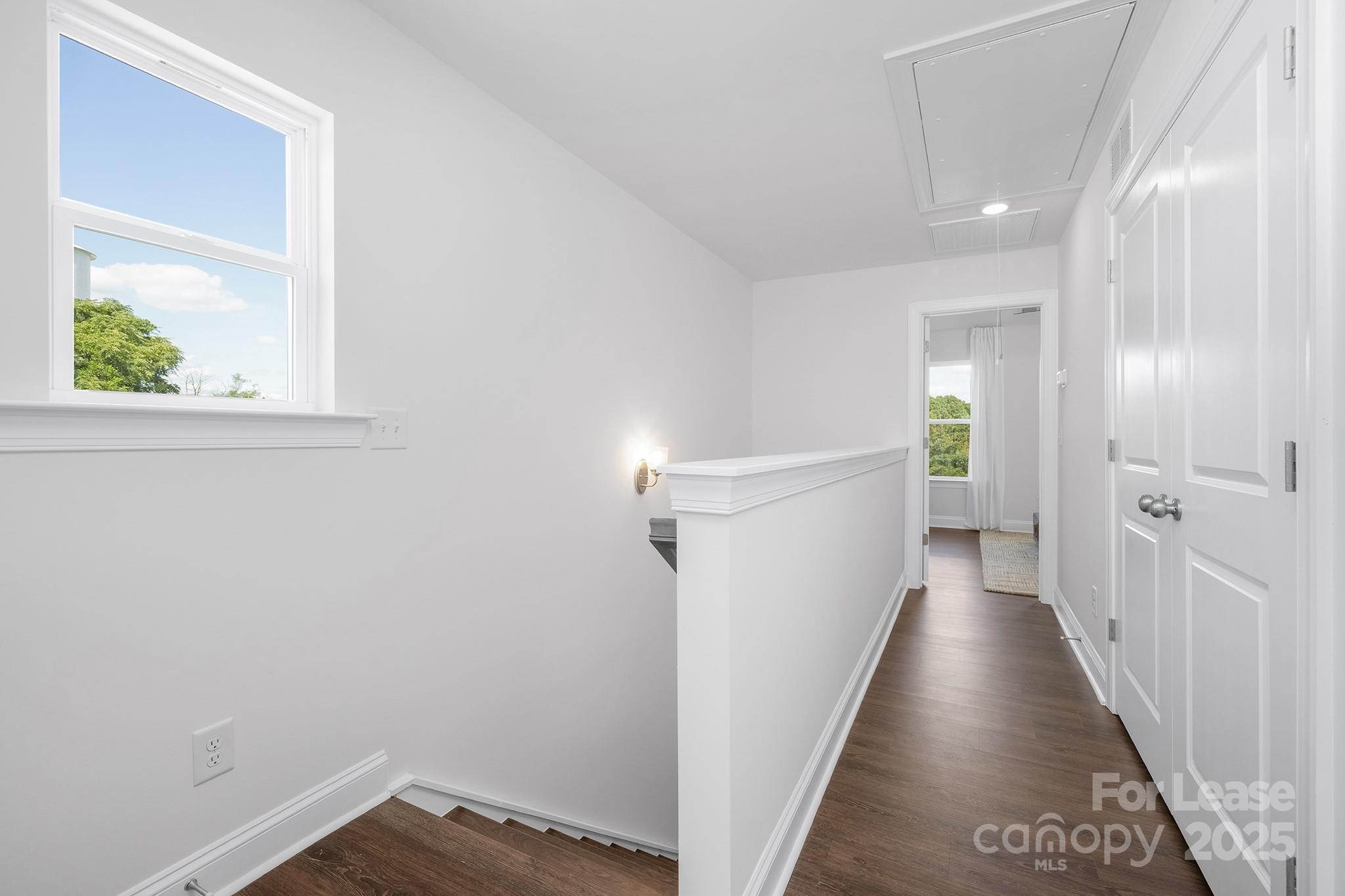 550 Beatties Ford Road Charlotte, NC 28216 - Photo 18 of 23 a view of a hallway with wooden floor