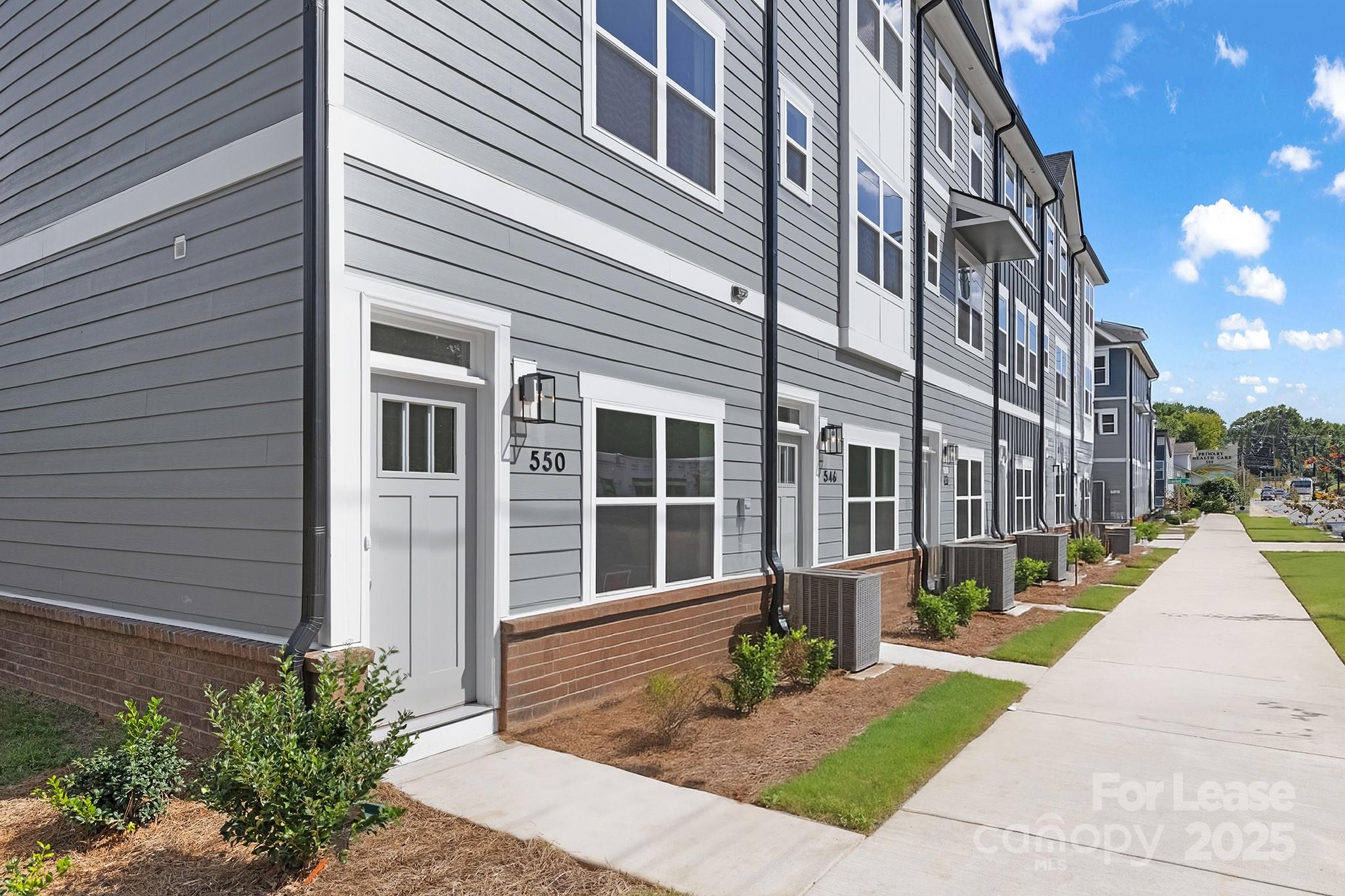 550 Beatties Ford Road Charlotte, NC 28216 - Photo 3 of 23 a view of a building with a yard