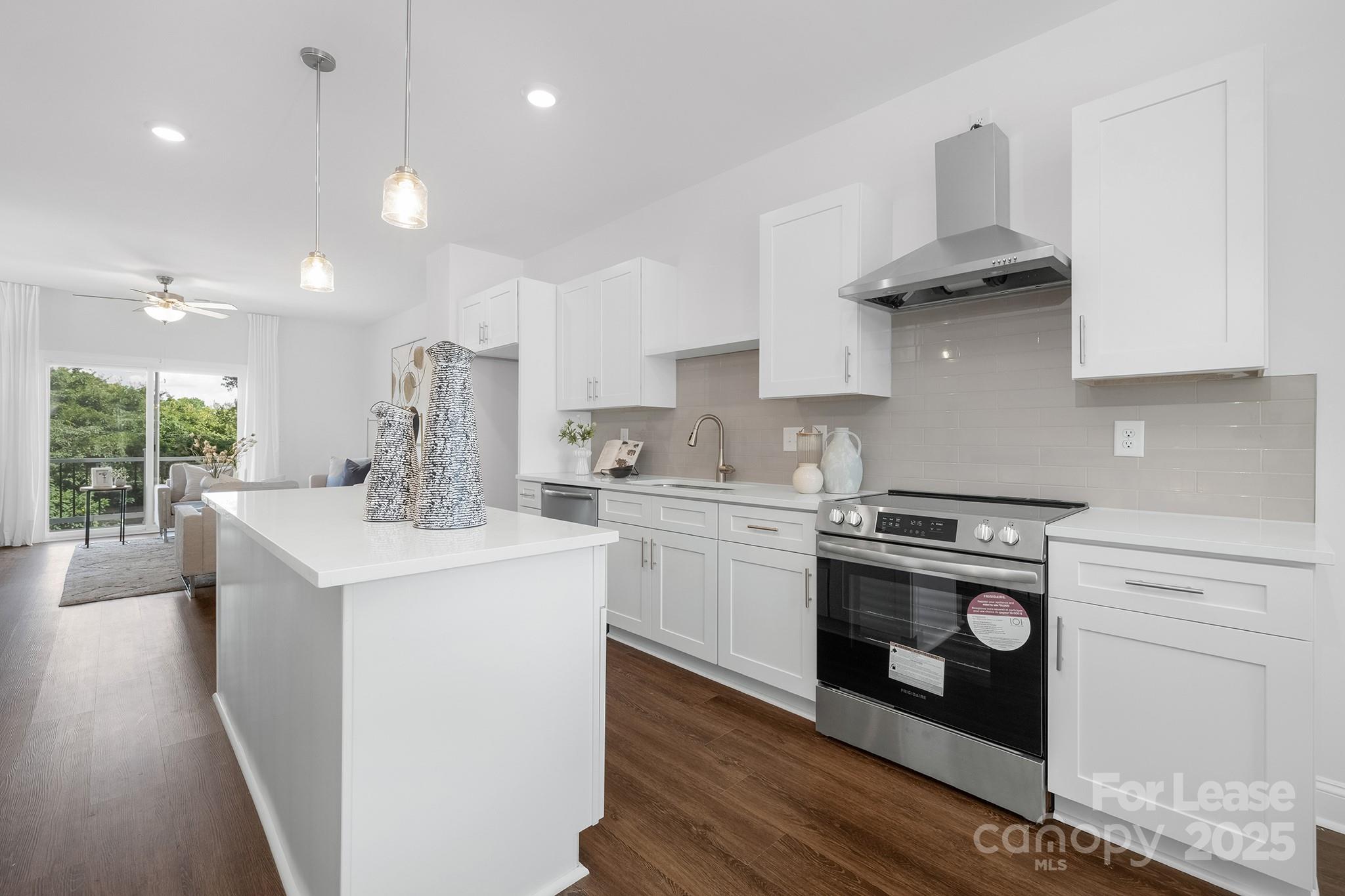 550 Beatties Ford Road Charlotte, NC 28216 - Photo 4 of 23 a kitchen with a stove a sink and a refrigerator