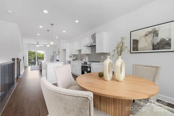 a dining room with furniture and a kitchen view