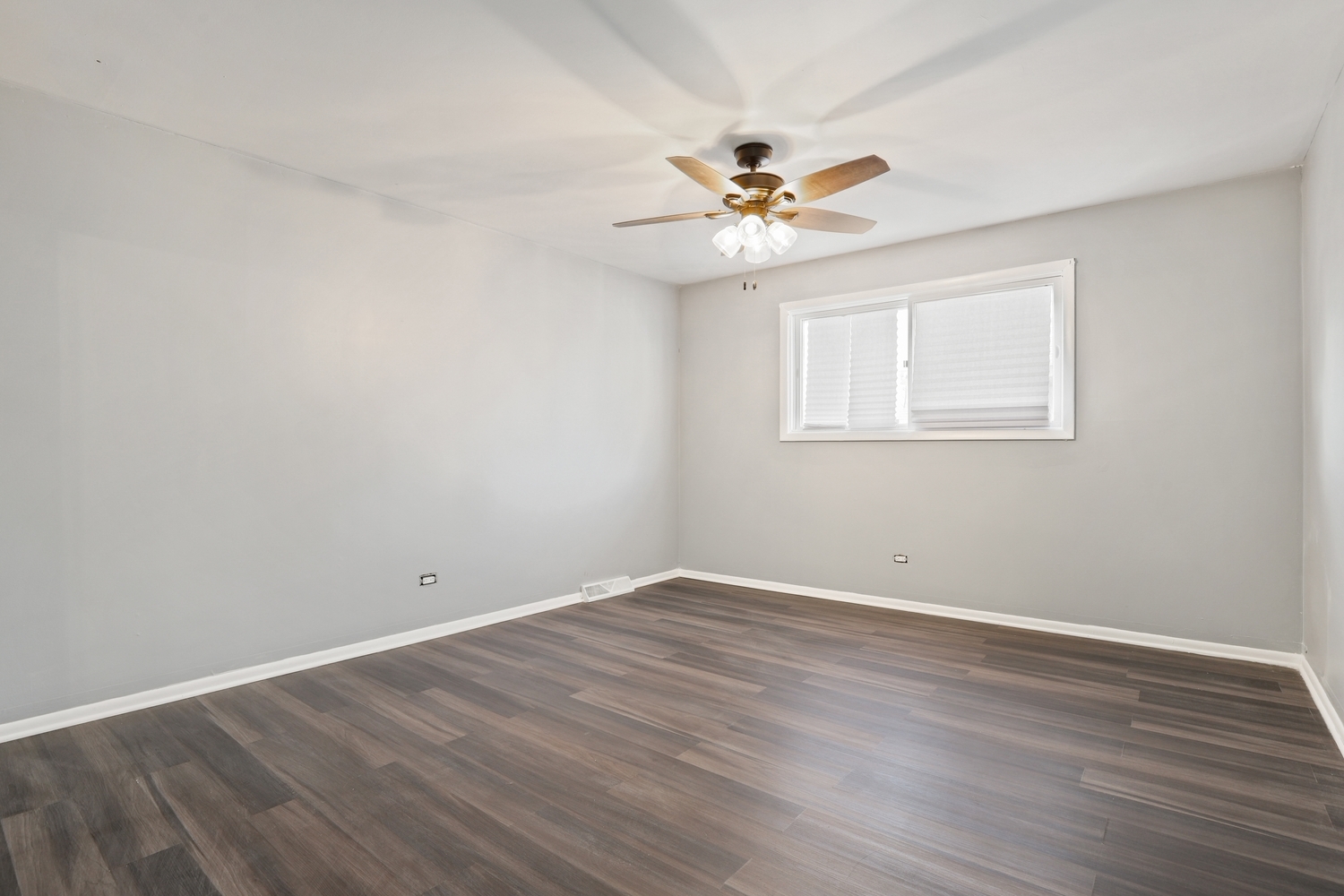 3518 South Manor Drive Lansing, IL 60438 - Photo 13 of 27 an empty room with wooden floor window and ceiling fan