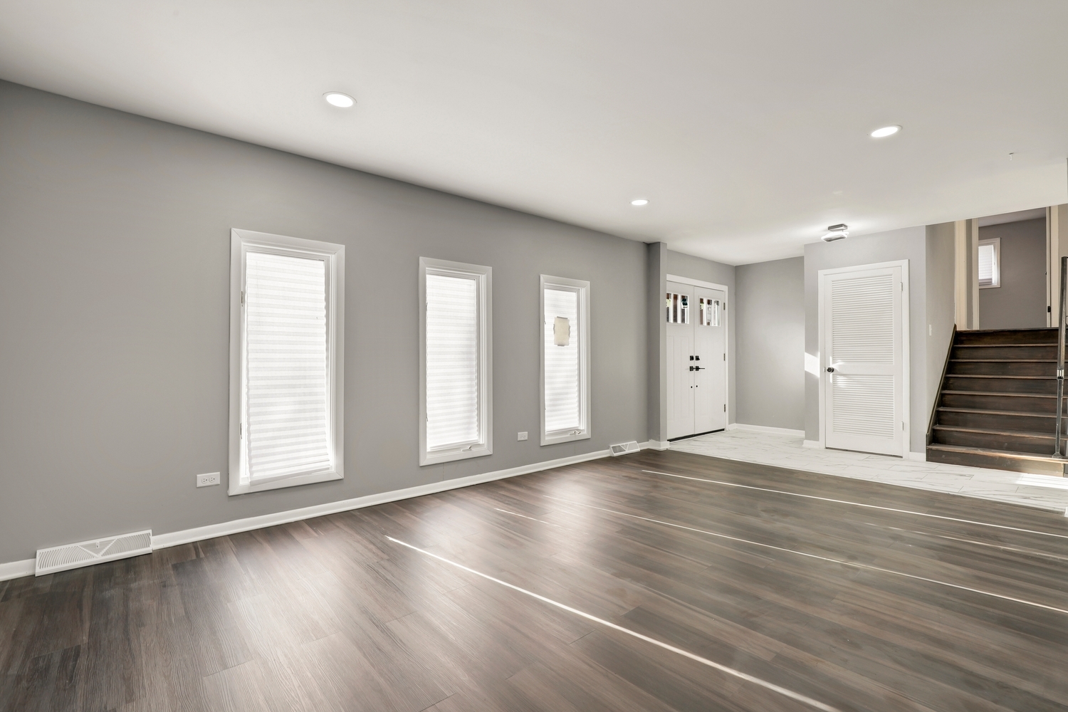 3518 South Manor Drive Lansing, IL 60438 - Photo 3 of 27 an empty room with wooden floor and windows