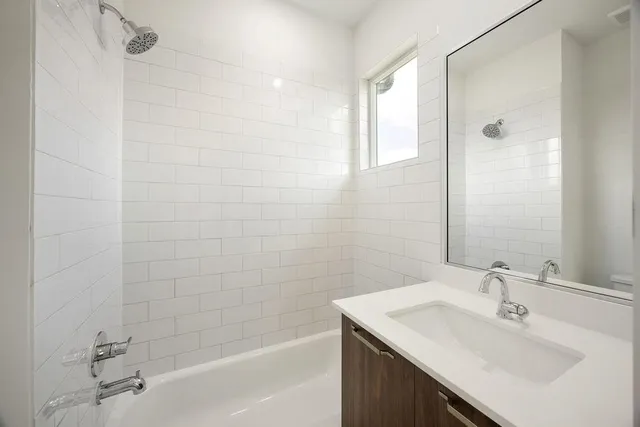 a bathroom with a sink shower and a bathtub