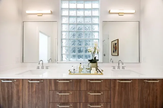 a bathroom with a double vanity sink and a mirror