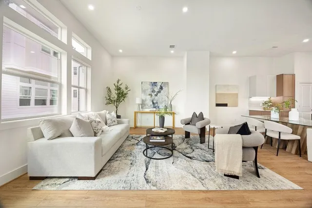 a living room with furniture and wooden floor