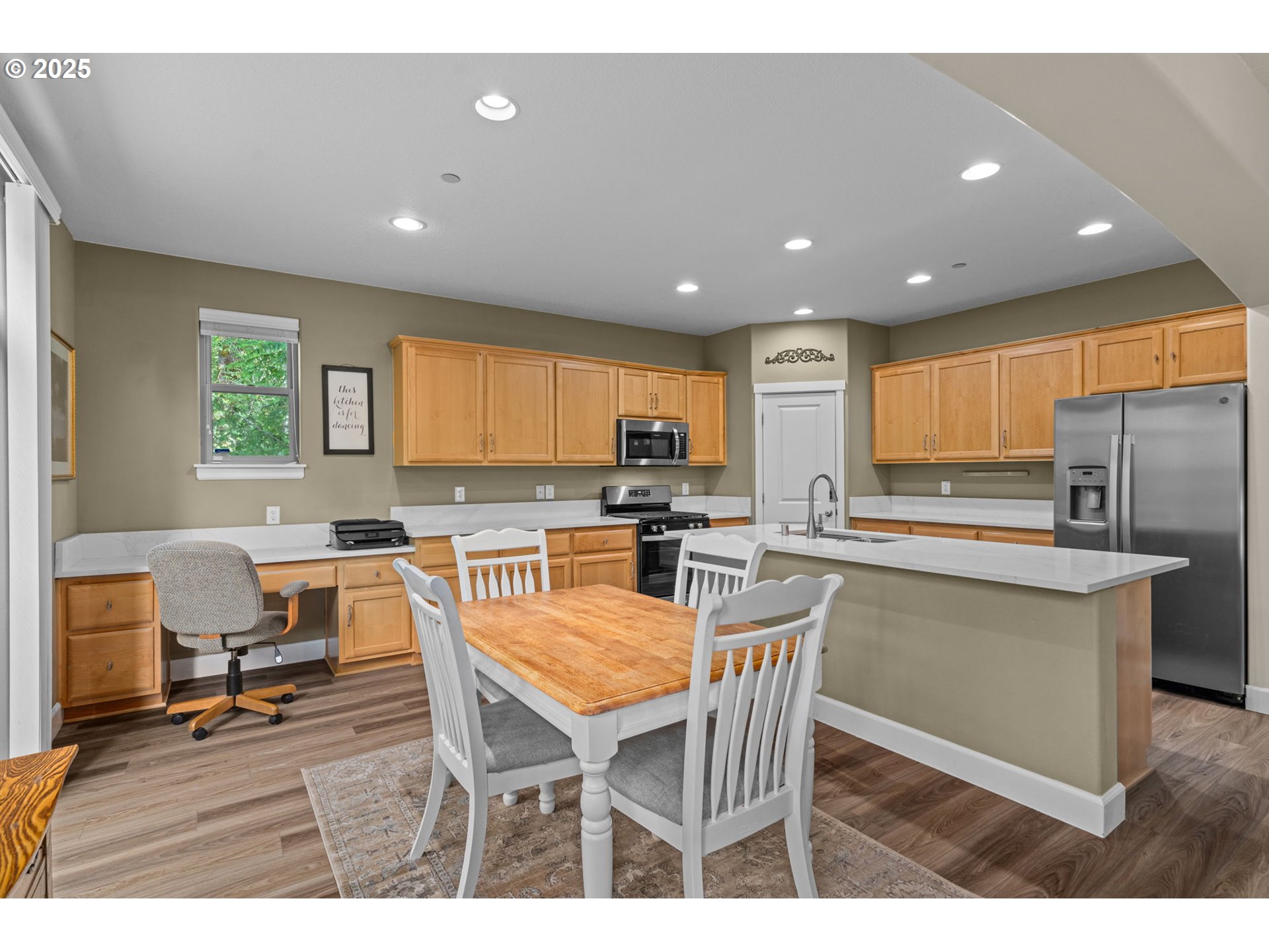 5717 Northwest 26th Avenue Camas, WA 98607 - Photo 11 of 35 a dining room with stainless steel appliances a dining table chairs and granite counter tops