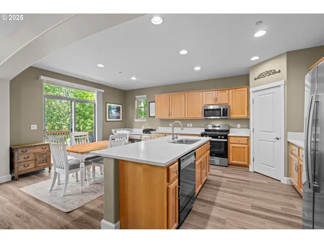 a kitchen with a sink a counter top stainless steel appliances and cabinets