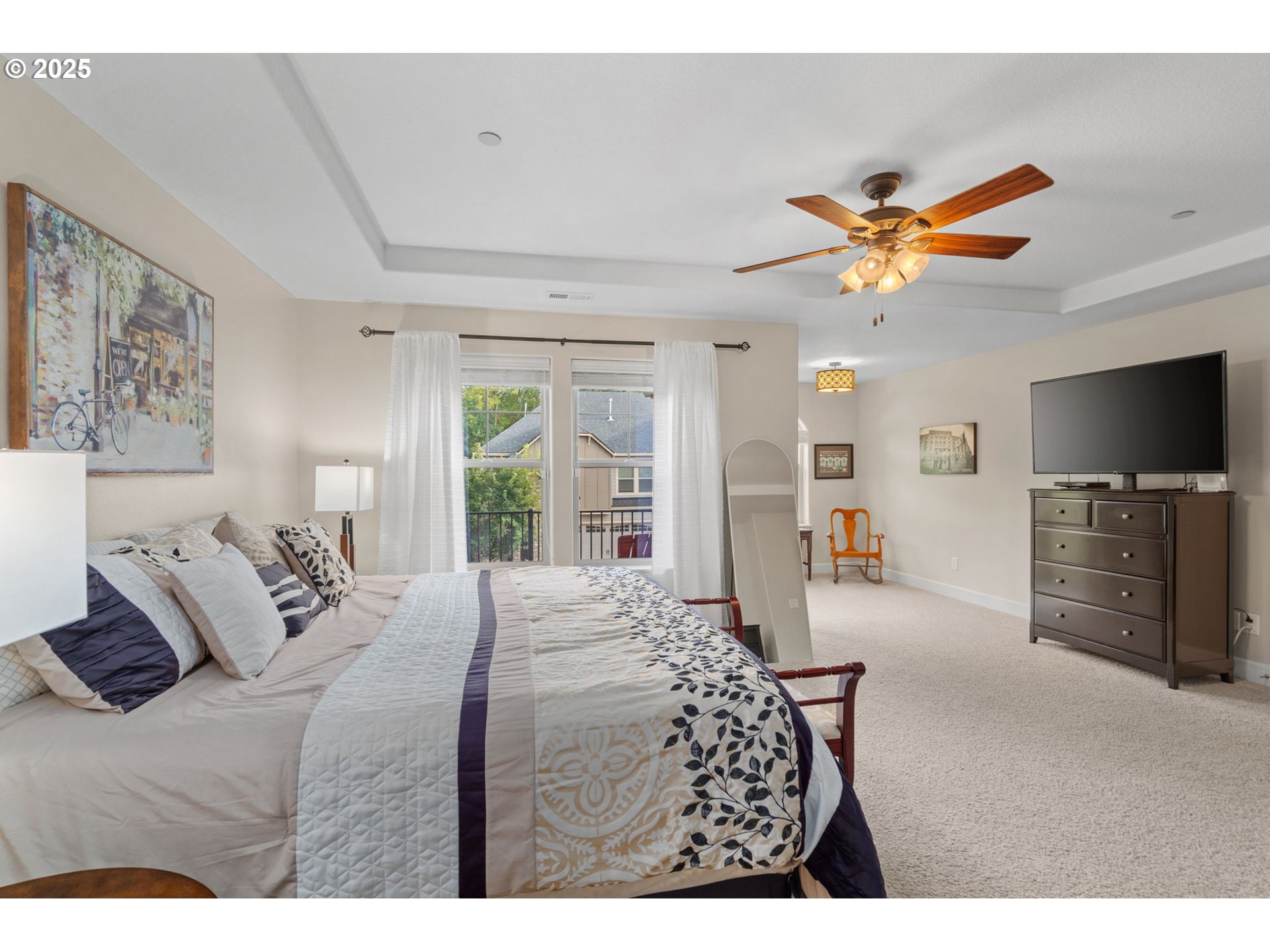 5717 Northwest 26th Avenue Camas, WA 98607 - Photo 19 of 35 a bedroom with a bed a flat screen tv and a chandelier