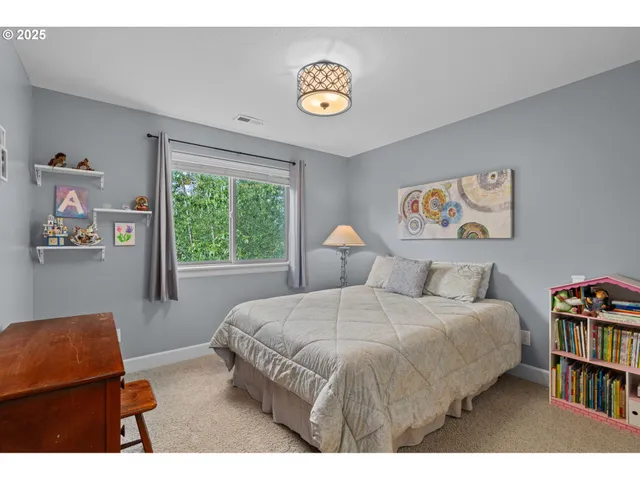 a bedroom with a bed and a book shelf