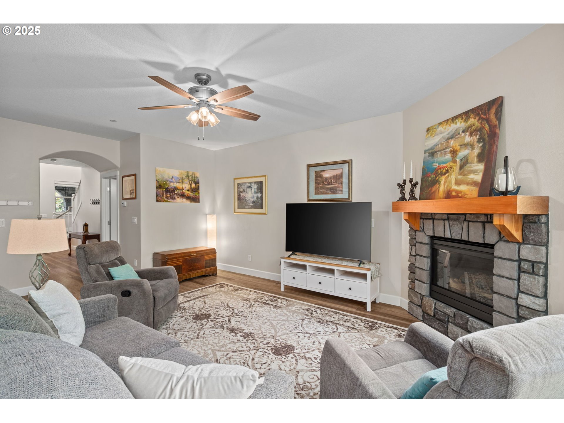 5717 Northwest 26th Avenue Camas, WA 98607 - Photo 7 of 35 a living room with furniture a flat screen tv and a fireplace