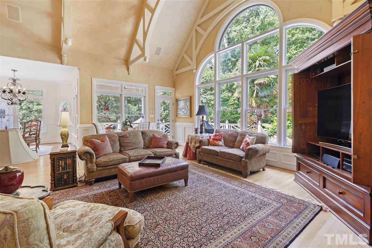 8423 Bournemouth Drive Raleigh, NC 27615 - Photo 11 of 30 a living room with furniture a rug and a flat screen tv