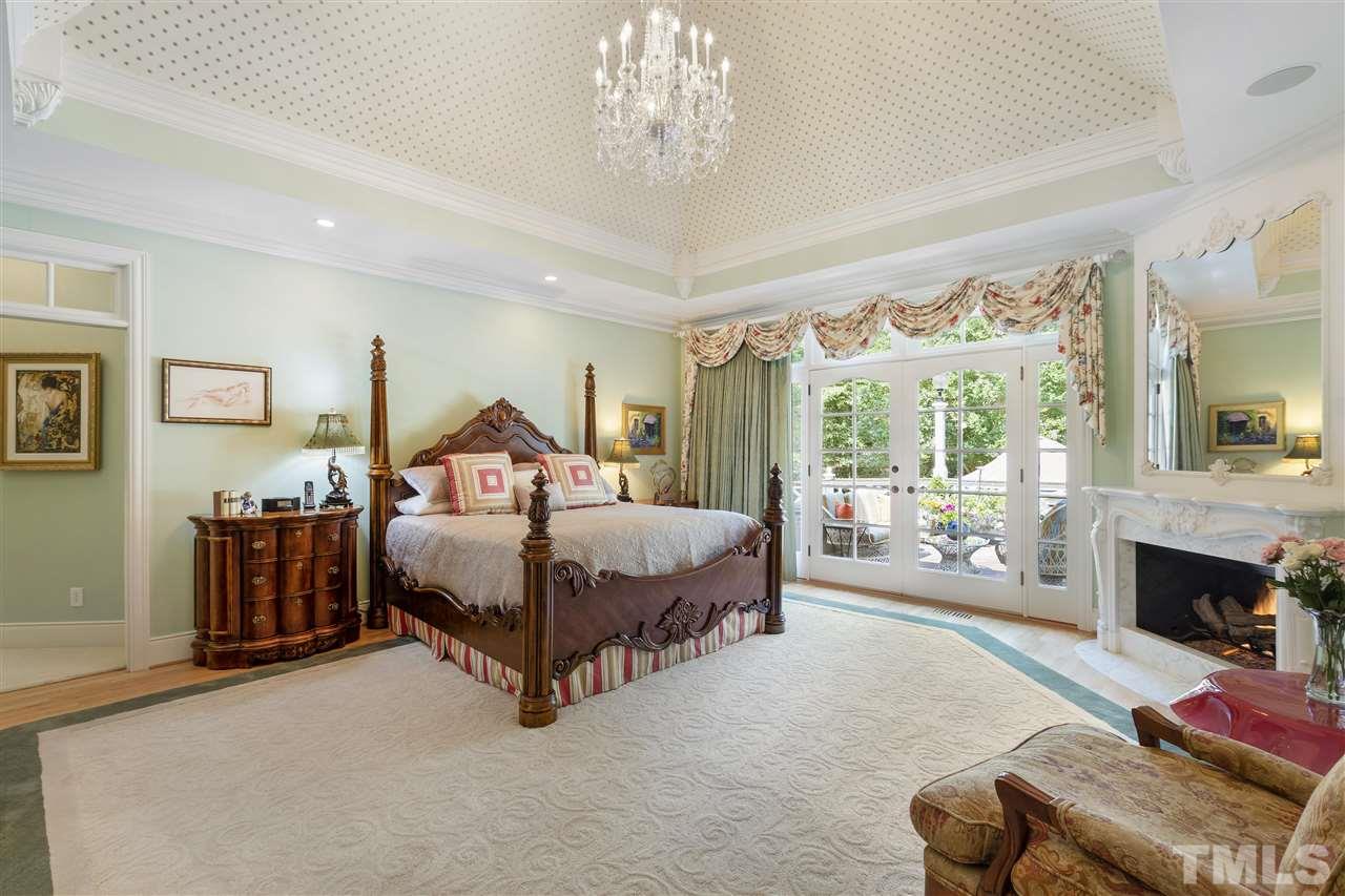 8423 Bournemouth Drive Raleigh, NC 27615 - Photo 12 of 30 a spacious bedroom with a bed couch chandelier and a window