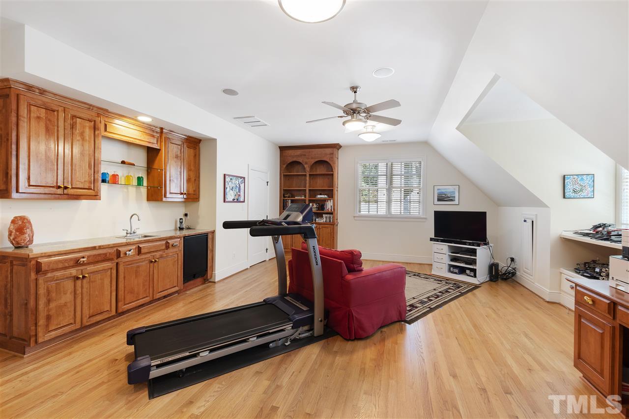 8423 Bournemouth Drive Raleigh, NC 27615 - Photo 17 of 30 a spacious bedroom with a bed a dresser and flat screen tv