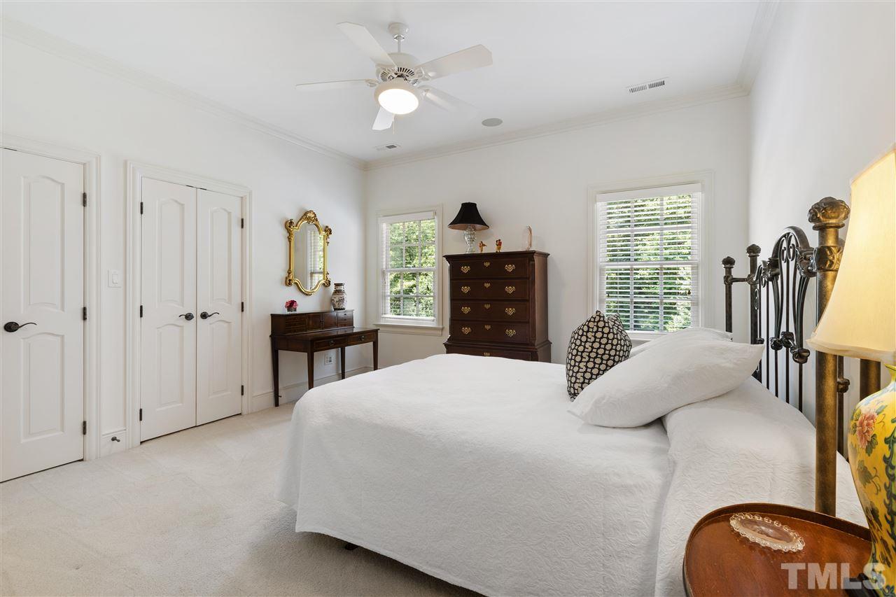 8423 Bournemouth Drive Raleigh, NC 27615 - Photo 18 of 30 a bedroom with a bed dresser and a flat tv screen
