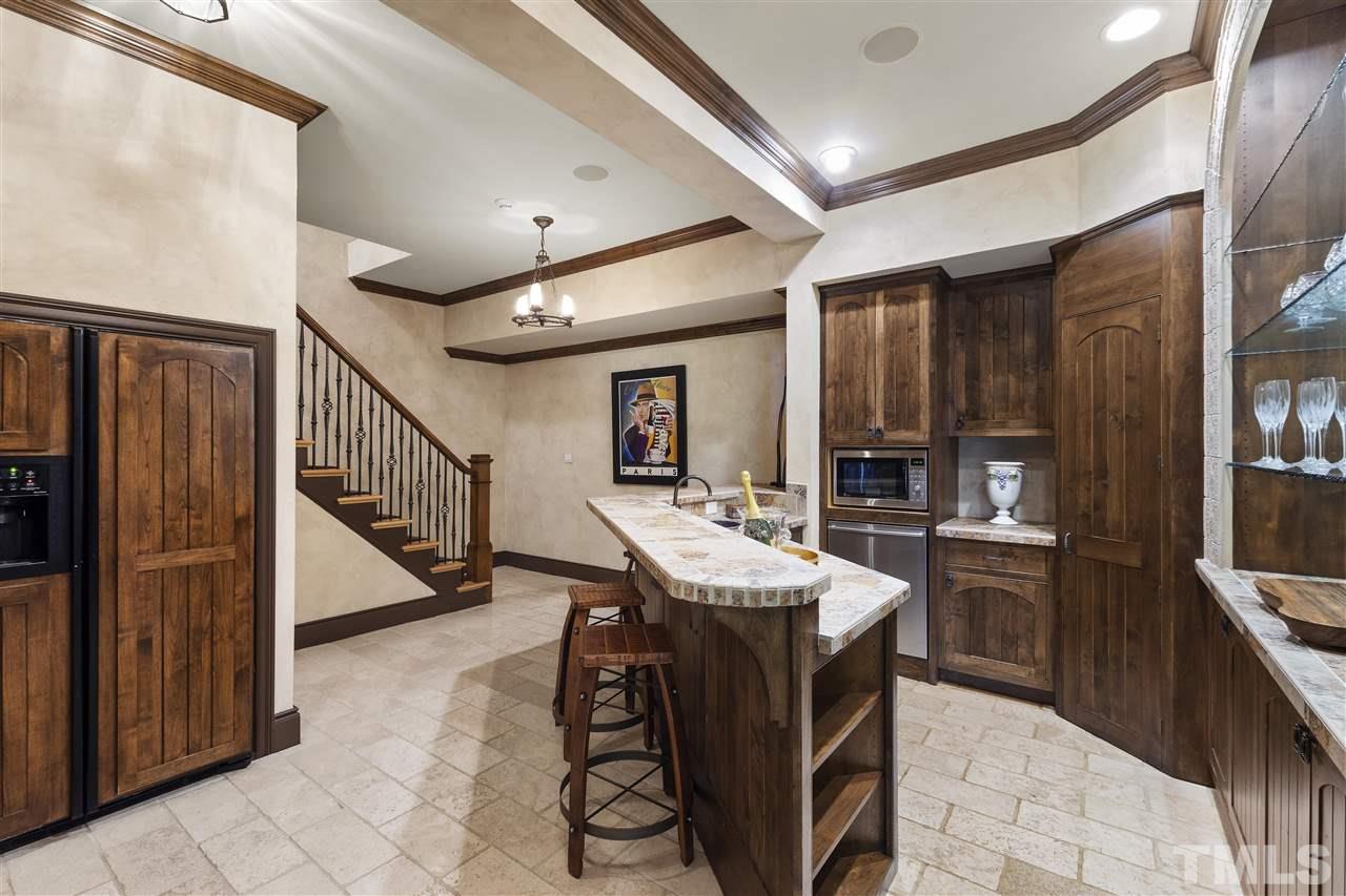 8423 Bournemouth Drive Raleigh, NC 27615 - Photo 20 of 30 a kitchen with stainless steel appliances granite countertop a sink and a refrigerator