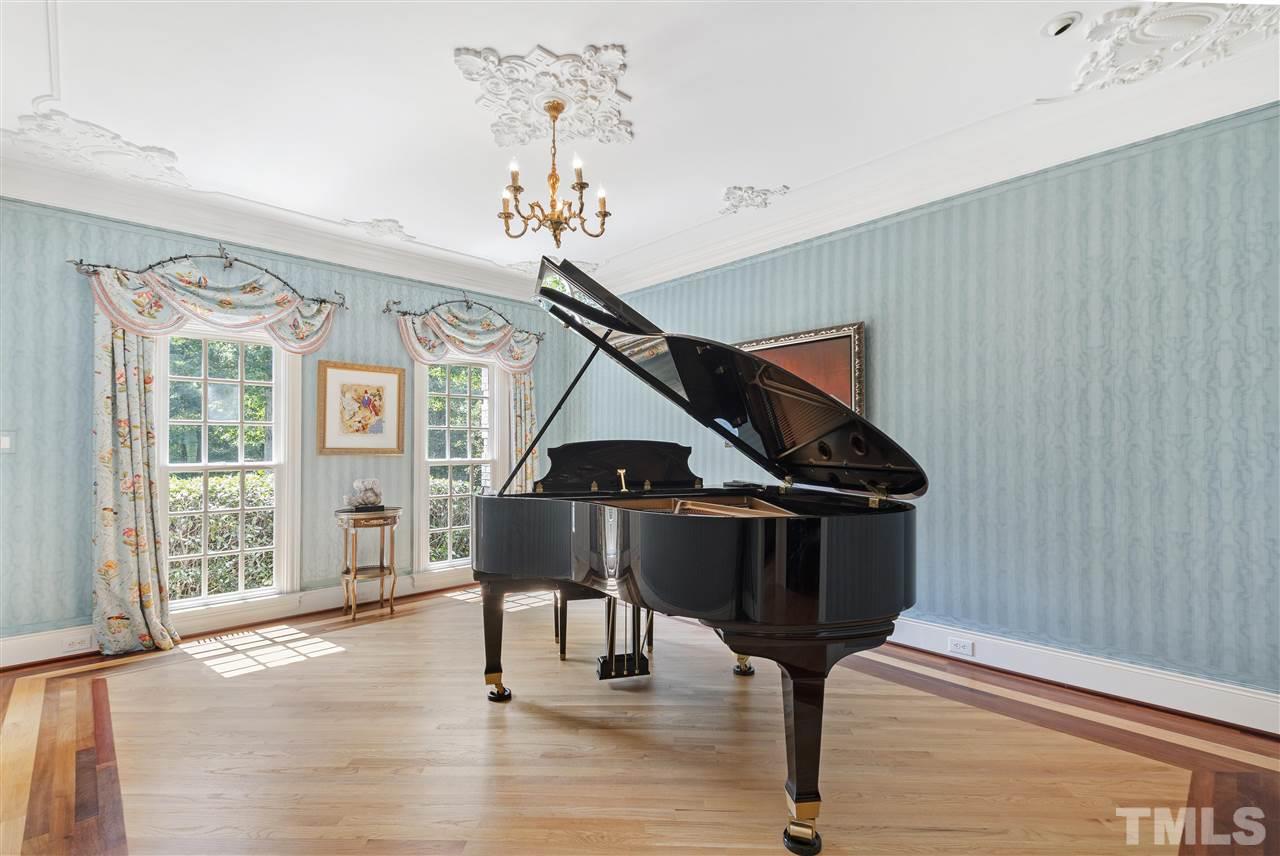 8423 Bournemouth Drive Raleigh, NC 27615 - Photo 4 of 30 a room with lots of furniture and wooden floor