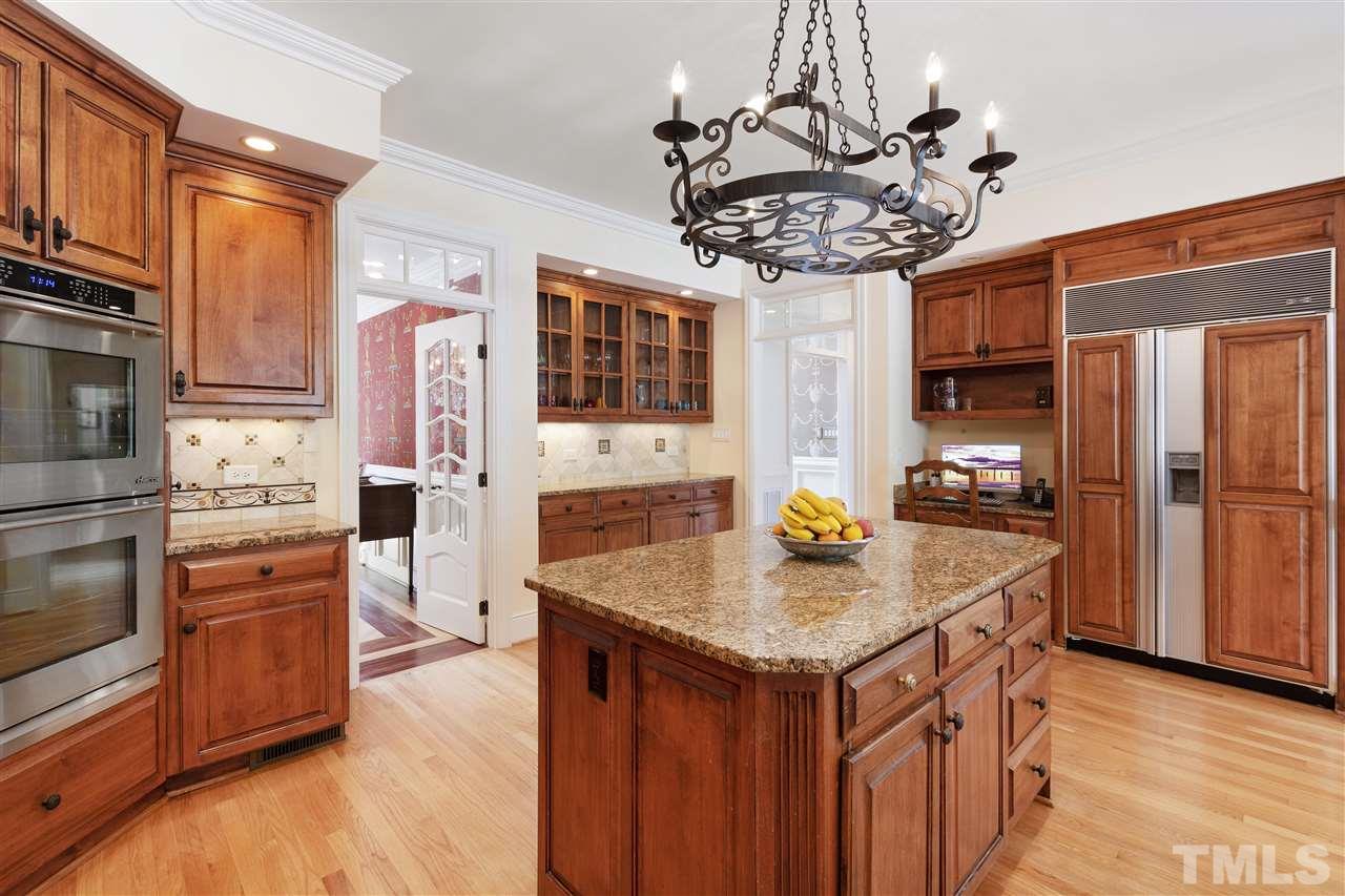 8423 Bournemouth Drive Raleigh, NC 27615 - Photo 8 of 30 a kitchen with stainless steel appliances granite countertop a sink and a refrigerator