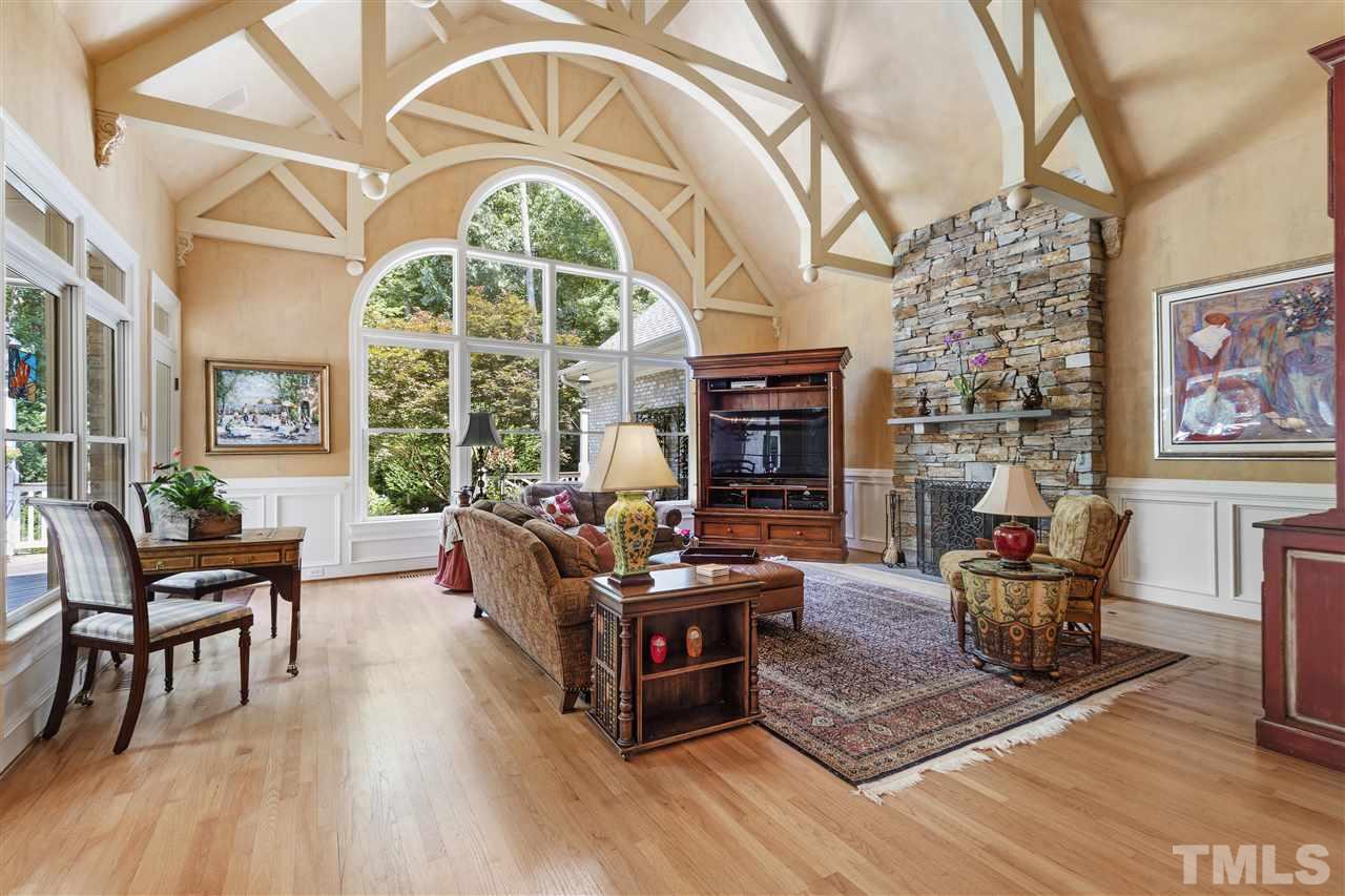 8423 Bournemouth Drive Raleigh, NC 27615 - Photo 10 of 30 a living room with furniture a fireplace and a large window