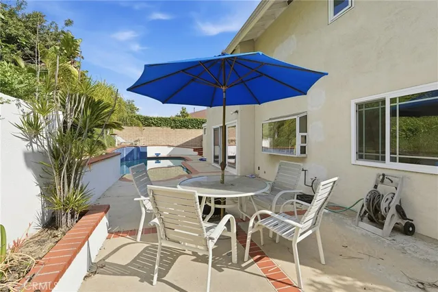 an aerial view of a house with a garden and trees
