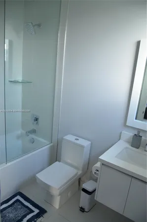 a bedroom with a bed window and a flat screen tv