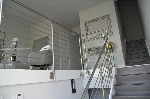 a view of staircase with white walls