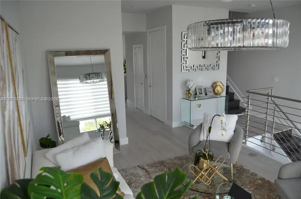 a living room with furniture and a chandelier