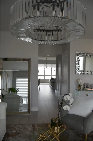 a view of a dining room with furniture wooden floor and chandelier