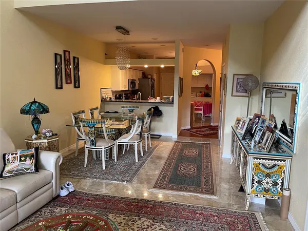a living room with furniture a rug and white walls