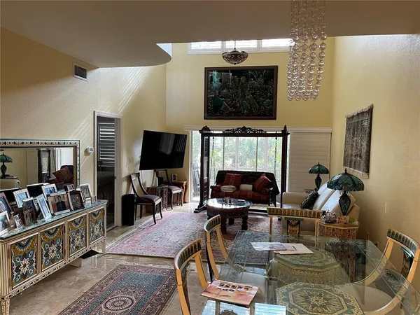 a living room with furniture a flat screen tv and kitchen view