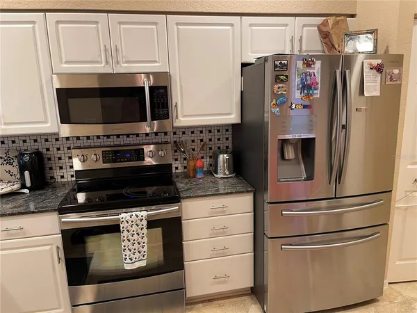a kitchen with appliances and cabinets