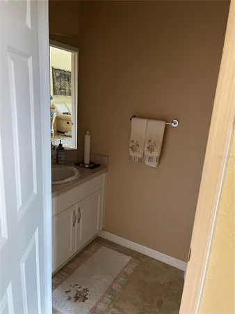 a bathroom with a granite countertop sink a mirror and window