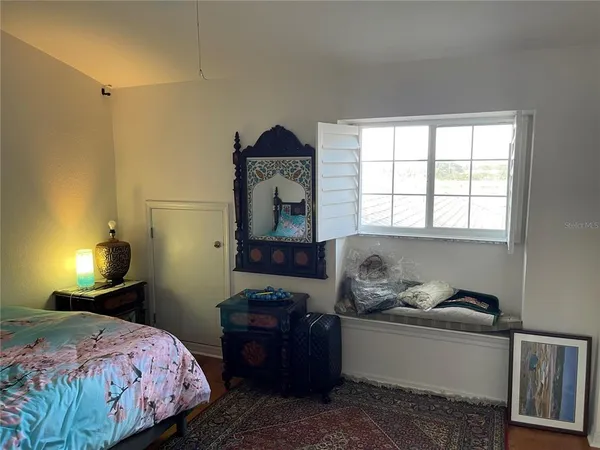 a bedroom with a bed and a window