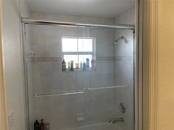 a bathroom with a glass shower door