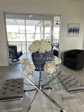 a living room with furniture and a floor to ceiling window
