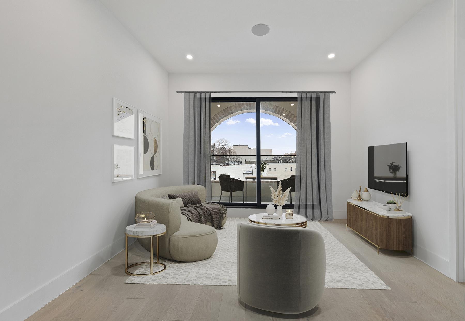 62 Veronica Place, Unit 2A Brooklyn, NY 11226 - Photo 3 of 7 a living room with furniture large windows and a flat screen tv