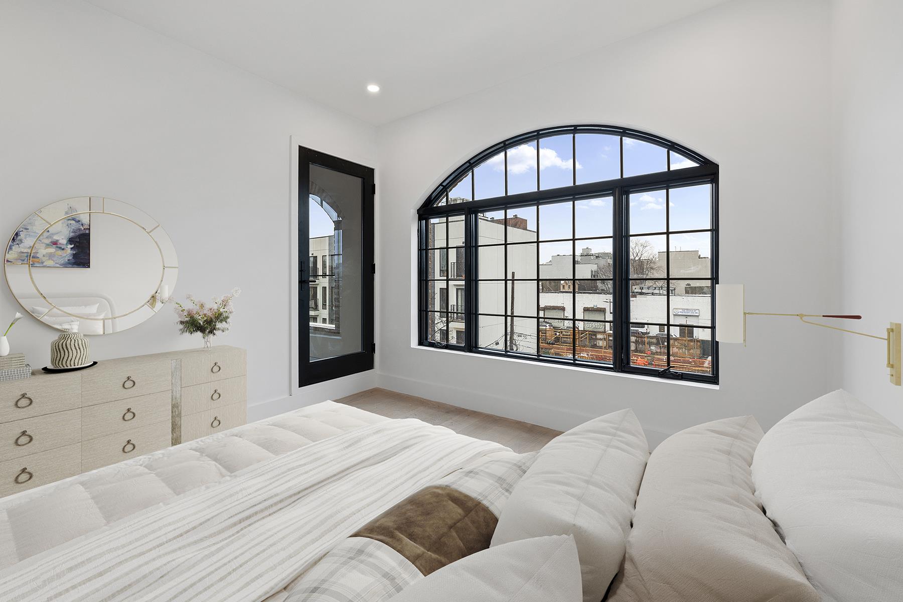 62 Veronica Place, Unit 2A Brooklyn, NY 11226 - Photo 5 of 7 a spacious bedroom with a large bed and a window